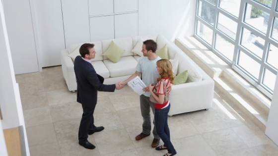 real estate agent with a couple inside a house